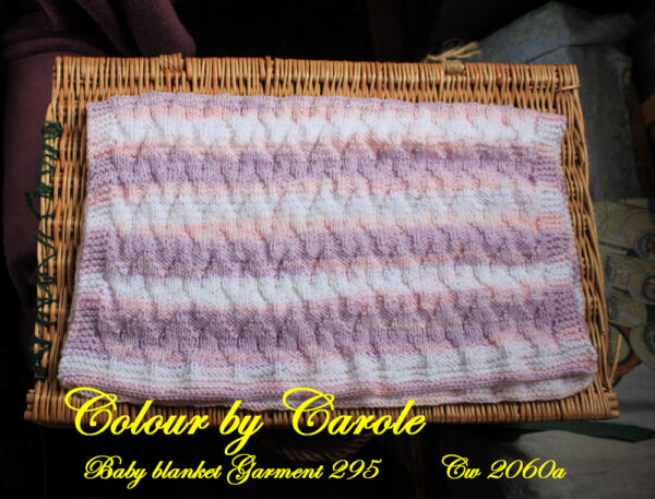 Chevron baby blanket in pastel shades of pinks, lilac, and whites.