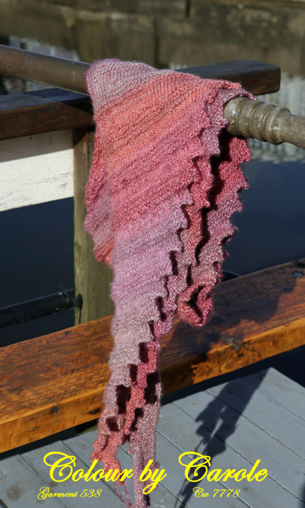 Shades of pink and orange Landscape Huggy Shawl A shades of pink and orange Landscape Dragon tooth shawl hand knitted aboard the narrow boat “Emma Maye” in Lancashire by Carole Wareing of Colin and Carole’s Creations. This unique garment is an adult sized shawl knitted from Landscape yarn, hence the name. The yarn was produced by James C Brett and this is shade no LS08, but is now sadly out of production. The garment is created from a yarn with shades of pinks and orange’s, autumn shades. The shawl is 74 inch long and 11 inch deep at its widest point and has about 64 dragon’s teeth. The yarn is a mix of acrylic and 15% wool, so nice and warm. Price £20 includes free delivery to a UK address, please enquire for overseas delivery Garment 538 Cw 7778