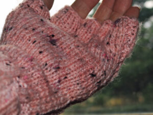 Pink tweedy fingerless gloves A pair of pink fingerless gloves designed and hand knitted by Carole Wareing of Colin and Carole’s Creations and The Wool Boat. These are adult sized gloves for a person with larger hands, and are quite long in the cuff which can be rolled over for extra warmth, ideal for gardening, typing, mechanicing, It work, locking, bicycling.... The gloves are for sale for £10.00 including delivery to a uk address They are knitted from J C Bretts a pink with brown flecks shade of Top Value double knitting acrylic yarn.