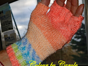 Orange Harmony fingerless gloves A pair of fingerless gloves created from a yarn with shades of Orange, blues and a touch of yellow. Orange, blues and a touch of yellow fingerless gloves designed and hand knitted by Carole Wareing of Colin and Carole’s Creations and The Wool Boat. These are adult sized gloves ideal for gardening, typing, mechanicing, It work, locking, bicycling....