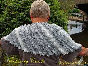 A Dragon tooth scarf hand knitted aboard the narrow boat “Emma Maye” in Lancashire by Carole Wareing of Colin and Carole’s Creations. This handcrafted garment is an adult sized shawl, knitted from a yarn available from The Wool Boat which is produced by James C Brett. The yarn used for this shawl is an acrylic yarn from the James C Brett’s “Marble” range, shade MT 1 The colours are blacks, whites and greys. The stitches used to create this shawl have produced a textured structure to the garment. The yarn is an acrylic one, very warm and snuggly and easy maintaince. The shawl is 70 inch long and 12 inch deep at its widest point and has about 64 dragon’s teeth. The price is £20 including free postage to a uk address, please enquire about overseas postage rates or come and pick up from The Wool Boat.