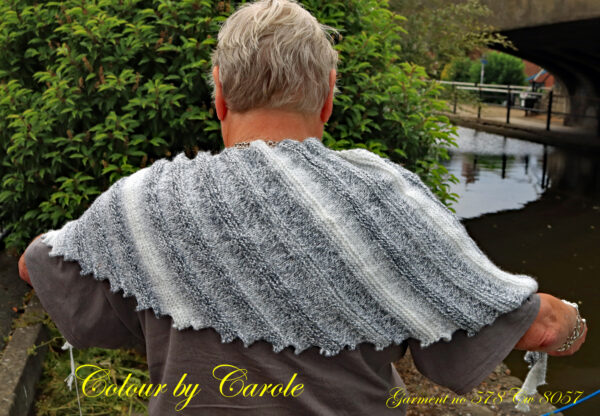 A Dragon tooth scarf hand knitted aboard the narrow boat “Emma Maye” in Lancashire by Carole Wareing of Colin and Carole’s Creations. This handcrafted garment is an adult sized shawl, knitted from a yarn available from The Wool Boat which is produced by James C Brett. The yarn used for this shawl is an acrylic yarn from the James C Brett’s “Marble” range, shade MT 1 The colours are blacks, whites and greys. The stitches used to create this shawl have produced a textured structure to the garment. The yarn is an acrylic one, very warm and snuggly and easy maintaince. The shawl is 70 inch long and 12 inch deep at its widest point and has about 64 dragon’s teeth. The price is £20 including free postage to a uk address, please enquire about overseas postage rates or come and pick up from The Wool Boat.
