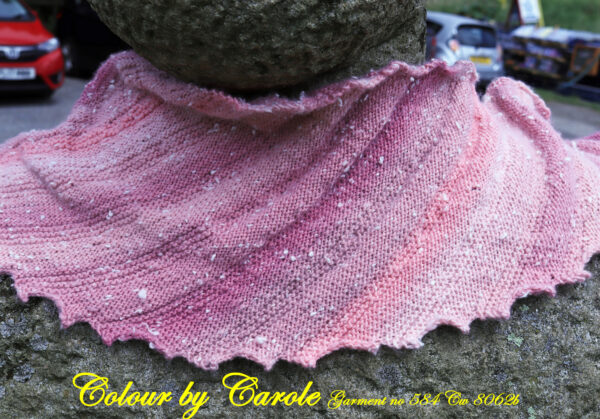 Pink Dragon tooth Northern lights shawl A Dragon tooth scarf hand knitted aboard the narrow boat “Emma Maye” in Lancashire by Carole Wareing of Colin and Carole’s Creations. This handcrafted garment is an adult sized shawl, knitted from a yarn available from The Wool Boat which is produced by James C Brett. The yarn used for this shawl is an acrylic yarn from the James C Brett’s “Northern Lights” range, shade NL8. The Northern Lights range has now been taken out of production though we do have a few balls left for sale on The Wool Boat as of 9.7.2022.