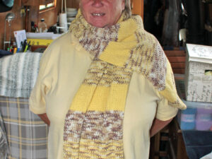 Yellow and beige wrap Carole has hand knitted this wrap from J C Bretts Cotton on yarn, which is a cotton and acrylic mix. Two shades have been used to create this garment, a solid yellow one and a variegated brown one to provide a nice contrast. The wrap is lovely and warm, great for keeping the wearer warm and toasty. This wrap would make a nice present for someone, for Christmas or birthday, or just to say I love you. The wrap is approximately 68 inches long and 15 inches wide. The yarn is machine washable Hand knitted aboard the narrow boat “Emma Maye” from where the wrap can be picked up or it can be posted out to a uk address.