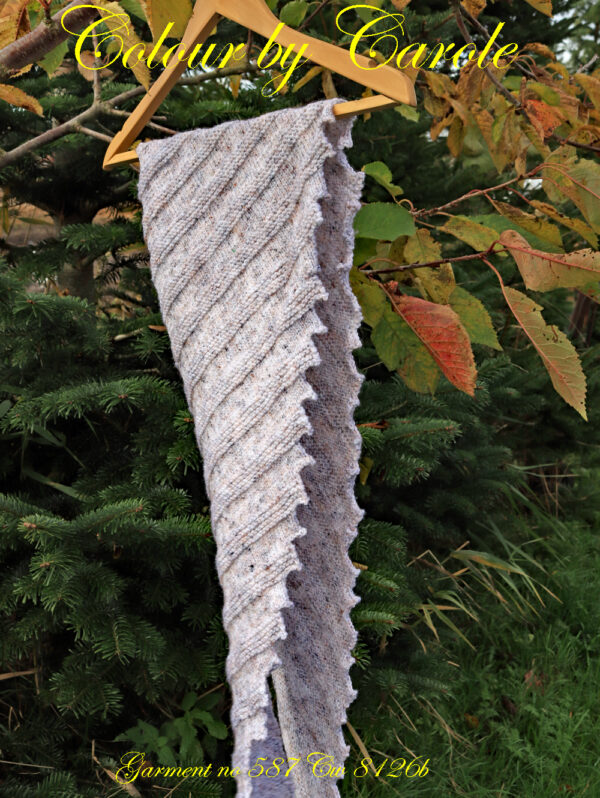 Dragon tooth Misty shawl in shades of light grey with fawn flecks. A Dragon tooth shawl hand knitted aboard the narrow boat “Emma Maye” in Lancashire by Carole Wareing of Colin and Carole’s Creations. This unique garment will make a great handmade present for someone or indeed for yourself. This garment, an adult sized shawl, knitted from some shades of this yarn being available from The Wool Boat, which is the last stock we can get as it has been discontinued from Bretts range. The yarn used for this shawl is an acrylic and viscose mix from the James C Brett’s “Misty” range, shade R1. The colours are shades of light greys with brown flecks. The stitches used to create this shawl have produced a textured and ribbed structure to the garment. The yarn is an acrylic one, very warm and snuggly and easy maintaince. The shawl is 76 inch long and 12 inch deep at its widest point and has about 66 dragon’s teeth. The price is £20, come and pick up from The Wool Boat, or can be posted out to a uk address with postage included in the £20.