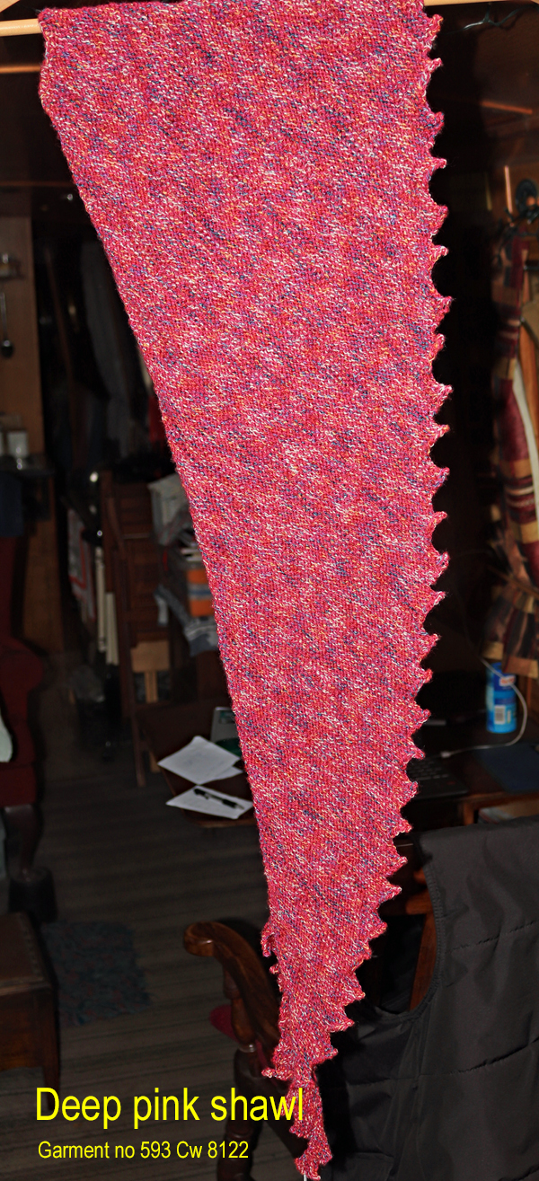 The stitch details of a Deep pink shawl hand knitted aboard the narrow boat “Emma Maye” in Lancashire by Carole Wareing of Colin and Carole’s Creations. This unique garment will make a great handmade present for someone or indeed for yourself. This garment, an adult sized shawl. The colours are shades of deep pink with blue, cream and fawn flecks. The stitches used to create this shawl have produced a textured and ribbed structure to the garment.