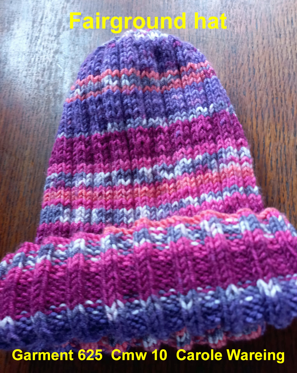 A striped hat hand knitted aboard the narrow boat “Emma Maye” in Lancashire by Carole Wareing of Colin and Carole’s Creations. Great for an adult or teenager, Created from a shade G15 from J C Brett’s “Fairground” range. Colour – Purple, Orange, grey, magenta in horizontal stripes of varying depths. Machine washable at 30 degrees C Would make a nice set with the fairground scarf garment 624 knitted from the same yarn. The price is £15 including delivery to a uk address, or come and pick up from The Wool Boat. Garment 625