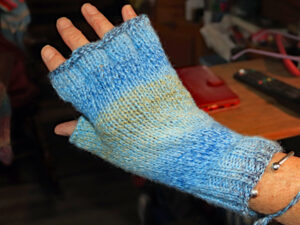A pair of blue and wheat fingerless gloves designed and hand knitted by Carole Wareing of Colin and Carole’s Creations and The Wool Boat. These are adult sized gloves ideal for gardening, typing, mechanicing, It work, locking, bicycling.... The gloves are for sale for £7.50 or £11.00 including delivery to a uk address They are knitted from J C Bretts Marble double knitting acrylic yarn Shade MT2.