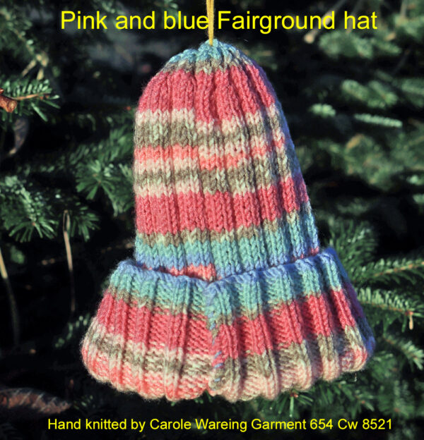 Fairground hat in Pink, blue and fawn shades. A striped hat hand knitted aboard the narrow boat “Emma Maye” in Lancashire by Carole Wareing of Colin and Carole’s Creations. Great for an adult or teenager, Colour – Pink, blue, and fawns in horizontal stripes of varying depths. Machine washable at 30 degrees C The price is £10 or £13 including delivery to a uk address Created from a shade G13 from J C Brett’s “Fairground” range which we stock on The Wool Boat.