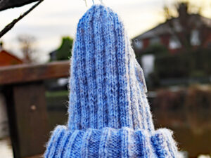 Misty hat in a light blue shades. A light blue adults hat hand knitted aboard the narrow boat “Emma Maye” in Lancashire by Carole Wareing of Colin and Carole’s Creations. Great for an adult or teenager, Colour –light blue Machine washable at 30 degrees C The price is £10 or £13 including delivery to a uk address Created from a shade Ro5 from J C Brett’s “Misty” range walls which is no longer produced but we do have a few balls left on The Wool Boat. Hand knitted by Carole Wareing Garment 663 Cw 8559