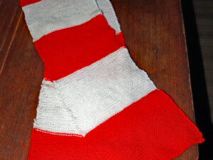 A retro style football scarf hand knitted by Carole Wareing from Colin and Caroles Creations and The Wool Boat. Knitted in a style that your mum or granny may have created back in the day. This yarn is in shades of red and white so could be used to show your support for a good range of clubs from Liverpool, Accrington Stanley, Brackley, Crewe, Sunderland…. The yarn acrylic so easy care, and the scarf is 64 inches long and 8 inches wide. These scarves can be knitted in a wide range of colours to show your support for your team. Please get in touch on 07931 356204 to place a order. Thanks Carole.