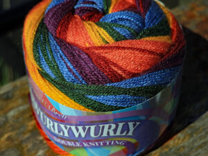 James C Bretts Swurlywurly Double knitting Yarn Swurley Wurley DK Yarn SRL 10 “Autumn Notes” Available in 10 shades of bright whirls of vibrant and variegated colours. The 10 shades in the range, with each 200-gram cake having enough yarn to knit or crochet a shawl or a scarf. Examples of shawls that Carole has knitted are here as well. 100% Acrylic Length 550m 599 yards per 200-gram cake Needle size 4 mm US6 Tension 22sts to 28 rows Knits to most D K patterns. Machine Washable 30° This one is SRL 10 named Autumn Notes in colours of oranges, blues and greens. This yarn can be posted out to a UK address which will plus postage and packing if applicable. Thank you for having a look, Carole, and Capt Col on The Wool Boat.