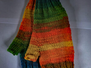 “Meadow flowers” Aurora Fingerless gloves Pastel blue, greens and yellow shades Aurora Fingerless gloves Aurora fingerless gloves in bright blue, greens and yellow shades. A variegated pair of fingerless gloves hand knitted aboard the narrow boat “Emma Maye” in Lancashire by Carole Wareing of Colin and Carole’s Creations. Great for an adult or teenager, Colour – Pastel blue, greens and yellow shades in horizontal stripes of varying depths. Acrylic and wool yarn, machine washable at 30 degrees C The price is £7.50 or £11 including delivery to a uk address Created from a shade AU12 named “Meadow Flowers” from J C Brett’s “Aurora” range which we stock on The Wool Boat. Hand knitted by Carole Wareing Garment 767 Cw 9352