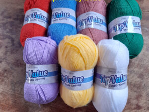 The UKHA, UK Hand knitting association, are organising a crochet along for April into May 2026, to produce a blanket named “Blossom”. The pattern will be realised over 7 weeks from the 7th of April 2026 through the UKHA website and Ravlery. We have put together a pack of the seven shades of Top Value from James C Brett that can be used for this project. The pack contains 18 balls altogether in the required quantities of each shade. These may produce a brighter blanket than the one shown.